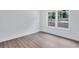 Bright bedroom featuring hardwood floors, white walls, and a large window for natural light at 2000 Grove Ave, East Point, GA 30344