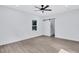 Bright bedroom with a ceiling fan and sliding barn door leading to the tiled shower at 2000 Grove Ave, East Point, GA 30344