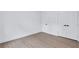 A simple, modern bedroom with hardwood floors and a double door closet for ample storage at 2000 Grove Ave, East Point, GA 30344