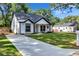 New construction exterior showcasing a well-manicured front yard, driveway and mailbox at 2000 Grove Ave, East Point, GA 30344