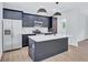 A modern kitchen showcases blue cabinets, stainless steel appliances, and a central island with stylish pendant lighting at 2000 Grove Ave, East Point, GA 30344