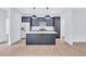 An open-concept kitchen featuring a kitchen island with white countertops and modern cabinets at 2000 Grove Ave, East Point, GA 30344