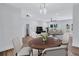 Staged open-concept living and dining area with hardwood floors and contemporary furnishings at 2000 Grove Ave, East Point, GA 30344