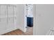Walk-in closet featuring wire shelving and a glimpse into the bathroom with a navy blue vanity at 2000 Grove Ave, East Point, GA 30344