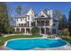 Beautiful backyard pool area with landscaped surroundings and stunning home facade at 3224 Lanier Ne Dr, Atlanta, GA 30319