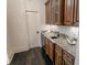 Elegant bar area with granite countertop, dark wood cabinets, and wine cooler at 3224 Lanier Ne Dr, Atlanta, GA 30319