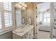 Bathroom vanity with marble countertop, classic fixtures, and view to the main bedroom at 3224 Lanier Ne Dr, Atlanta, GA 30319
