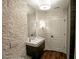 This bathroom features stone walls, modern fixtures, and a wood-look floor at 3224 Lanier Ne Dr, Atlanta, GA 30319