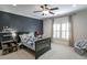 Cozy bedroom featuring a dark accent wall and natural light from the window at 3224 Lanier Ne Dr, Atlanta, GA 30319
