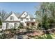 Beautiful white brick home with detailed landscaping, stone accents, and a covered front porch at 3224 Lanier Ne Dr, Atlanta, GA 30319