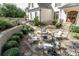 Cozy outdoor fire pit area with stone seating, landscaping, and inviting ambiance at 3224 Lanier Ne Dr, Atlanta, GA 30319