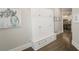 Hallway with built-in storage, bench seating, and hardwood floors leading to a kitchen at 3224 Lanier Ne Dr, Atlanta, GA 30319