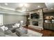 Comfortable living room featuring a stone fireplace, a large TV, and cozy seating at 3224 Lanier Ne Dr, Atlanta, GA 30319