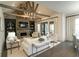 Cozy living room with vaulted ceilings, exposed beams, stone fireplace, and seamless flow to the outdoor space at 3224 Lanier Ne Dr, Atlanta, GA 30319