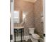 Stylish powder room featuring patterned wallpaper, modern fixtures, and a decorative mirror at 3224 Lanier Ne Dr, Atlanta, GA 30319