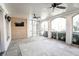 Large screened porch with fans, a tv, and brick walls at 3224 Lanier Ne Dr, Atlanta, GA 30319