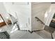 Elegant staircase with carpeted steps, white wainscoting, and stylish lighting fixtures at 3224 Lanier Ne Dr, Atlanta, GA 30319