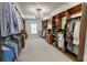 Expansive walk-in closet with custom shelving, chandelier, and window at 3224 Lanier Ne Dr, Atlanta, GA 30319