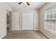 Bedroom with plush carpet, a built-in closet, and a window with blinds for privacy at 6983 Pine Shadow Way, Winston, GA 30187