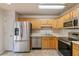 Kitchen featuring stainless steel appliances, oak cabinets, and tile floors at 6983 Pine Shadow Way, Winston, GA 30187