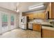 Bright eat-in kitchen featuring wood cabinets, tile floors, stainless steel appliances and backyard access at 6983 Pine Shadow Way, Winston, GA 30187