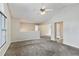 Open-concept living area featuring neutral carpet and wall paint with lots of natural light at 6983 Pine Shadow Way, Winston, GA 30187