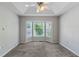 Spacious main bedroom featuring neutral walls, plush carpet, a ceiling fan and bay windows at 6983 Pine Shadow Way, Winston, GA 30187