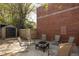 Cozy backyard patio with brick wall, small shed, and room for outdoor seating at 91 Chester Se Aly, Atlanta, GA 30316