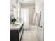 Well-lit bathroom featuring a double vanity with modern fixtures and a shower with a curtain at 91 Chester Se Aly, Atlanta, GA 30316