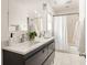 Well-lit bathroom featuring a double vanity with modern fixtures and a shower with a curtain at 91 Chester Se Aly, Atlanta, GA 30316