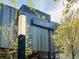 View of The Eastern building exterior with a steel and glass facade and green trees at 91 Chester Se Aly, Atlanta, GA 30316