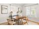 Bright dining room with large windows and hardwood floors, featuring a modern table at 91 Chester Se Aly, Atlanta, GA 30316