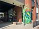 Exterior building entrance with mural and outdoor seating at 91 Chester Se Aly, Atlanta, GA 30316