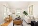 Bright living room features hardwood floors, neutral furniture, large windows, and stylish decor at 91 Chester Se Aly, Atlanta, GA 30316