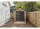 Backyard storage shed with double doors, concrete base, and neutral color scheme at 91 Chester Se Aly, Atlanta, GA 30316