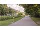 View of a walking path adjacent to green space and building with steel girders at 91 Chester Se Aly, Atlanta, GA 30316