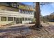 Backyard featuring a large tree and multiple windows along the back of the home at 138 Elysian Nw Way, Atlanta, GA 30327