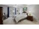 Bright bedroom featuring a ceiling fan, French doors, and decoratively patterned bedding at 138 Elysian Nw Way, Atlanta, GA 30327