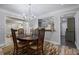 Bright dining room featuring a chandelier and opening into an updated kitchen with sage green cabinetry at 138 Elysian Nw Way, Atlanta, GA 30327