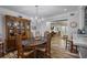 Bright dining room featuring a chandelier, wood floors, and a built in hutch for storage at 138 Elysian Nw Way, Atlanta, GA 30327