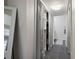 Hallway featuring slate floors, a walk in closet with sliding door, and a mirror at 138 Elysian Nw Way, Atlanta, GA 30327