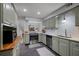 Updated kitchen featuring sage green cabinets, stainless steel appliances, and a subway tile backsplash at 138 Elysian Nw Way, Atlanta, GA 30327