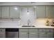 Close up of the kitchen featuring sage green cabinets, stainless steel appliances, and white countertops at 138 Elysian Nw Way, Atlanta, GA 30327