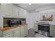 Kitchen area showcasing stainless steel appliances, a range oven, and sage green cabinetry at 138 Elysian Nw Way, Atlanta, GA 30327