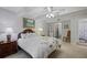 Cozy bedroom with a queen-sized bed, neutral carpet, ceiling fan, and view to bathroom, creating a peaceful retreat at 138 Elysian Nw Way, Atlanta, GA 30327