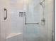 Luxurious walk-in shower featuring marble tile, a built-in seat, and a glass enclosure at 138 Elysian Nw Way, Atlanta, GA 30327
