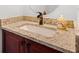 Bathroom vanity featuring a stone countertop and dark wooden cabinets at 2105 Rotunda Ct, Conyers, GA 30094