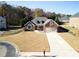 Well maintained single-Gathering home with manicured front lawn and an attached two-car garage at 2105 Rotunda Ct, Conyers, GA 30094