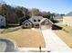 Beautiful home with a long driveway, an attached garage, and a well-maintained lawn at 2105 Rotunda Ct, Conyers, GA 30094