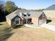 Charming two-story brick home featuring an attached garage and manicured front yard at 2105 Rotunda Ct, Conyers, GA 30094